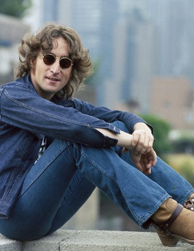 John Lennon wearing his NYC T-shirt and denim jacket on a roof in NYC. August 29, 1974. © Bob Gruen